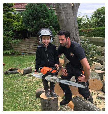 adult and child with chainsaw